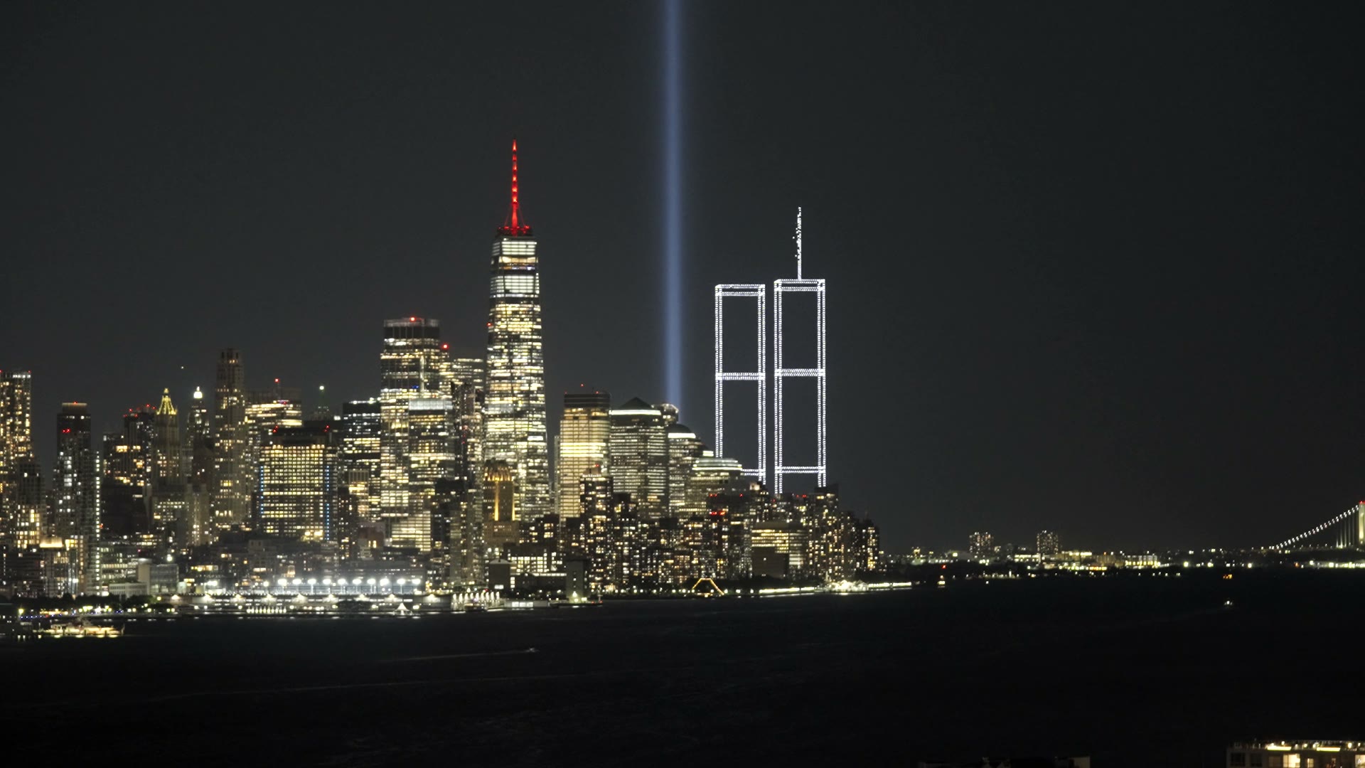 Film of the Lower Manhattan skyline at night seen from New Jersey, with the Tribute in Light and two towers of light