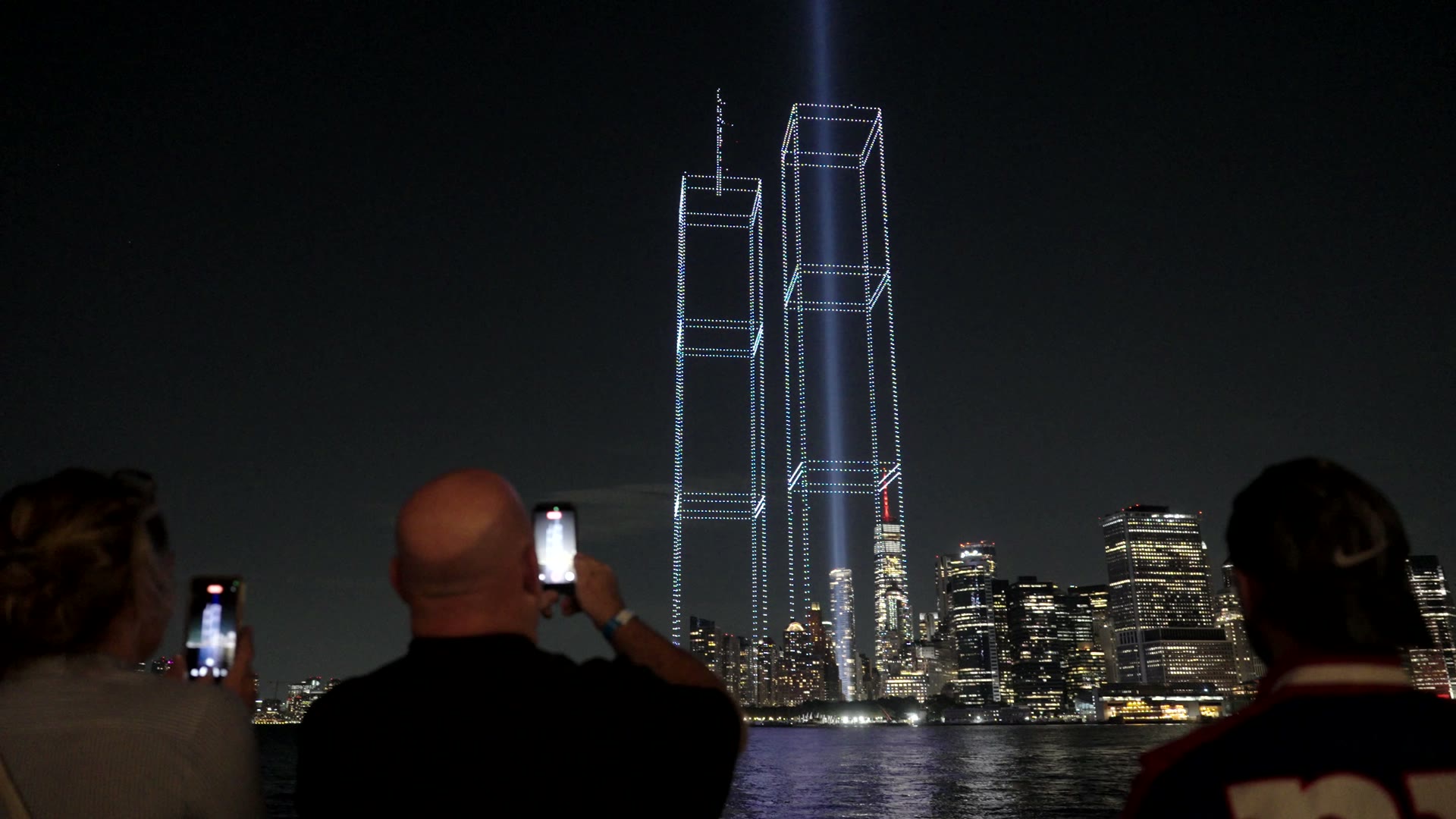 Film of Jim Smith on the New York waterfront filming the lights on his phone and speaking to camera
